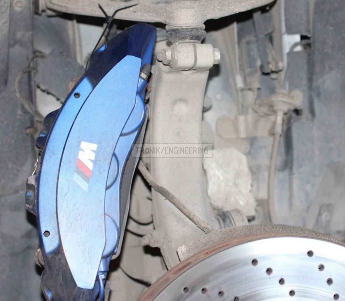 Unscrew radial munting screws & pull out brake pads & suspend caliper on plastic fixture